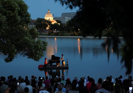 Classical pianist Violette Prevost performs on a floating platform at the Pradolongo lake, before the start of summer, in the working-class neighbourhood of Usera, Madrid, 18 June 