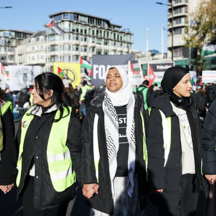Protestors march in solidarity with Palestine, demanding a ceasefire amid the ongoing conflict between Israel and the Palestinian Islamist group Hamas in London, 25 November