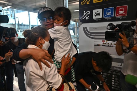 A Thai national hugs family members after arriving on a flight from Israel at Suvarnabhumi international airport in Bangkok, 12 October, as Thais working in Israel returned to the kingdom after a surprise attack on Israel by the Palestinian militant group Hamas