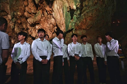 Members of the Thai Wild Boars youth football team gather inside the Tham Luang cave in the Mae Sai district in the northern province of Chiang Rai, 10 July, to mark the five-year anniversary of their rescue from inside the flooded cave 