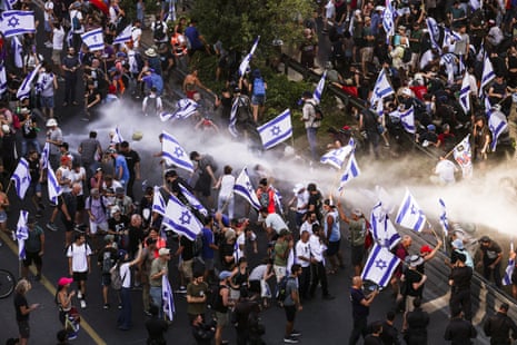 Police use a water cannon on protesters blocking a road that leads to the Prime Minister’s office at a demonstration following a parliament vote on a contested bill that limits Supreme Court powers to void some government decisions, in Jerusalem July 24