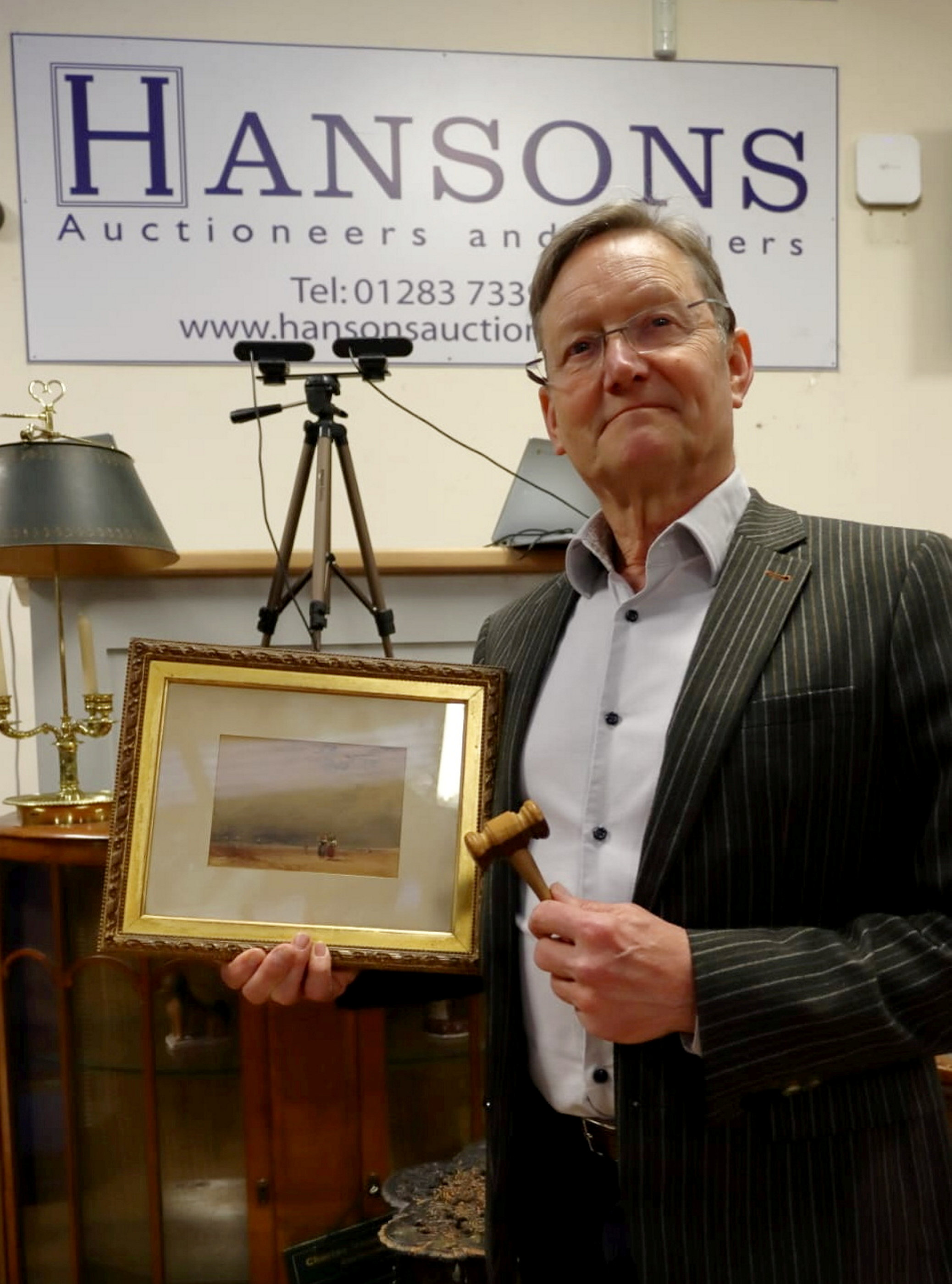Auctioneer Adrian Kinton with the David Cox watercolour which sold for £18,000