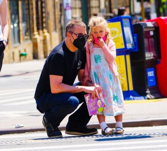 Bradley in the street with his daughter Lea de Seine - both wearing face masks