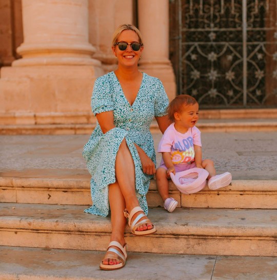 Claire and Olive on holiday, sitting on steps together