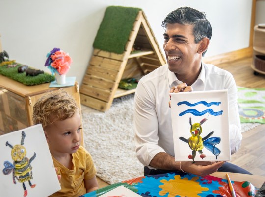 Rishi Sunak shows off a painting of a bee he created during a visit to a branch of Busy Bees nursery in Harrogate last summer