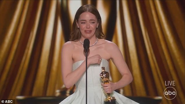 As she prepared to accept the trophy, the 35-year-old Cruella star could be seen holding the back of her Louis Vuitton peplum dress, after her zipper seemingly broke on the back