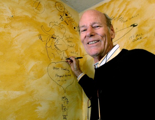 Babar author Laurent de Brunhoff signs the wall, while celebrating 75 years of the book on Friday, April 21, 2006 