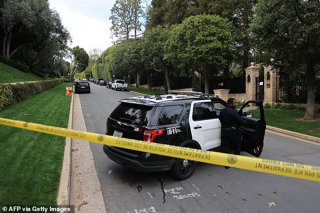 The inquiry was being directed by Homeland Security Investigations agents in New York, where he was accused by a former girlfriend R&B singer Cassie Ventura in a lawsuit filed in federal court in November of engaging in sex trafficking. Pictured: LAPD officers block the road to Diddy's California home