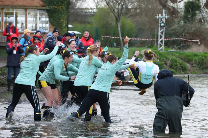 Cambridge cox Kate Crowley is thrown into the River Thames to celebrate victory in 2023