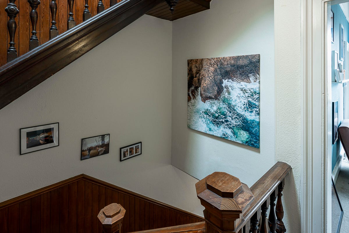 Image of a square canvas print hanging over stairs