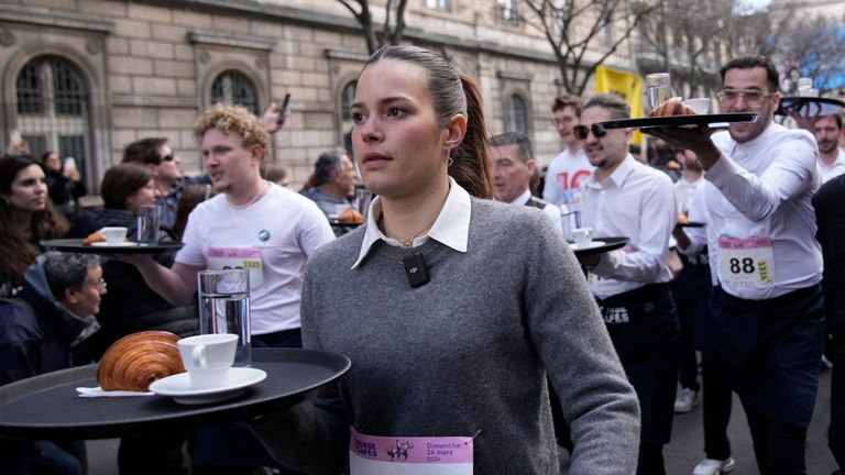 Pic: AP
Waiters carry trays with a cup of coffee, a croissant and a glass of water as they take part in a waiter&#39;s run through the streets of Paris, Sunday, March 24, 2024. (AP Photo/Christophe Ena)