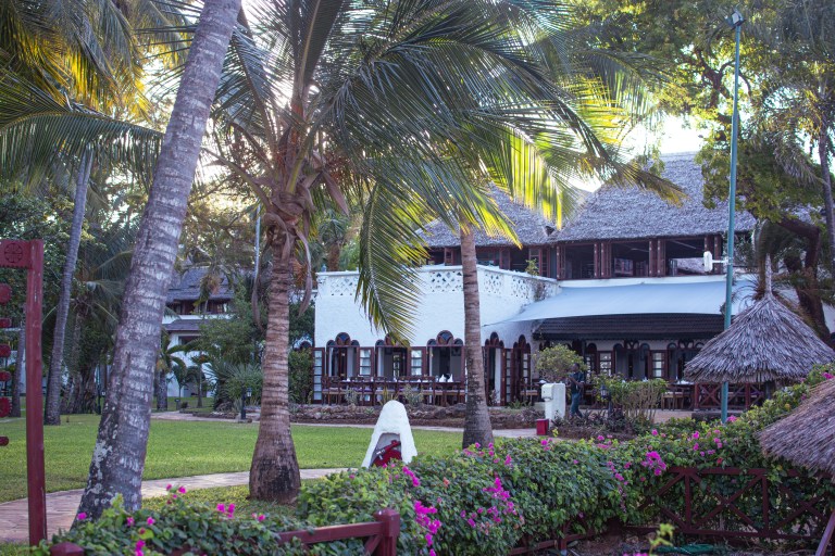 Serena Beach Resort with palm trees and white stone walls