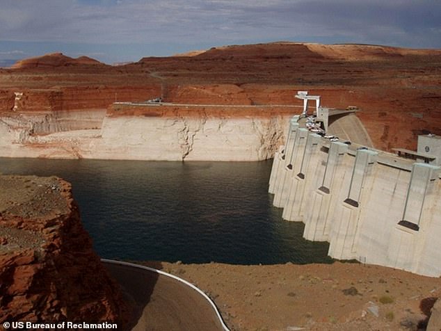 On the Lake Powell side of Glen Canyon Dam, the hydropower penstocks can be seen above the water level. These inlets, situated above the river outlet works, feed water to power turbines.