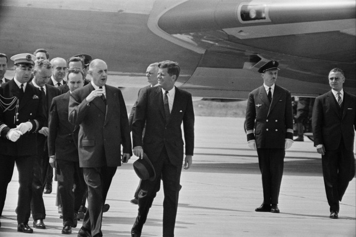 Former US President John Fitzgerald Kennedy, centre, is welcomed by General Charles de Gaulle