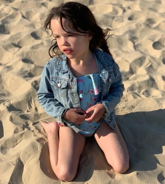 Annabelle sitting on the sand