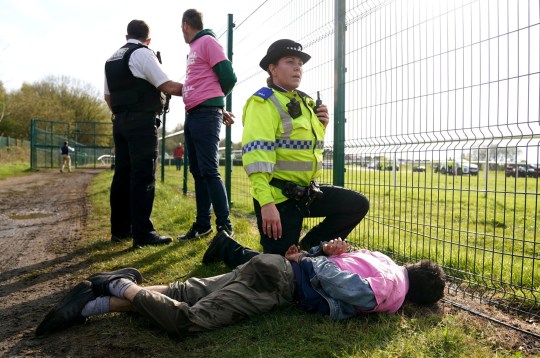 Protesters are detained by police during day three of the Randox Grand National Festival at Aintree Racecourse, Liverpool. Picture date: Saturday April 15, 2023. PA Photo. See PA story PROTEST Aintree. Photo credit should read: Tim Goode/PA Wire RESTRICTIONS: Editorial Use only, commercial use is subject to prior permission from The Jockey Club/Aintree Racecourse.