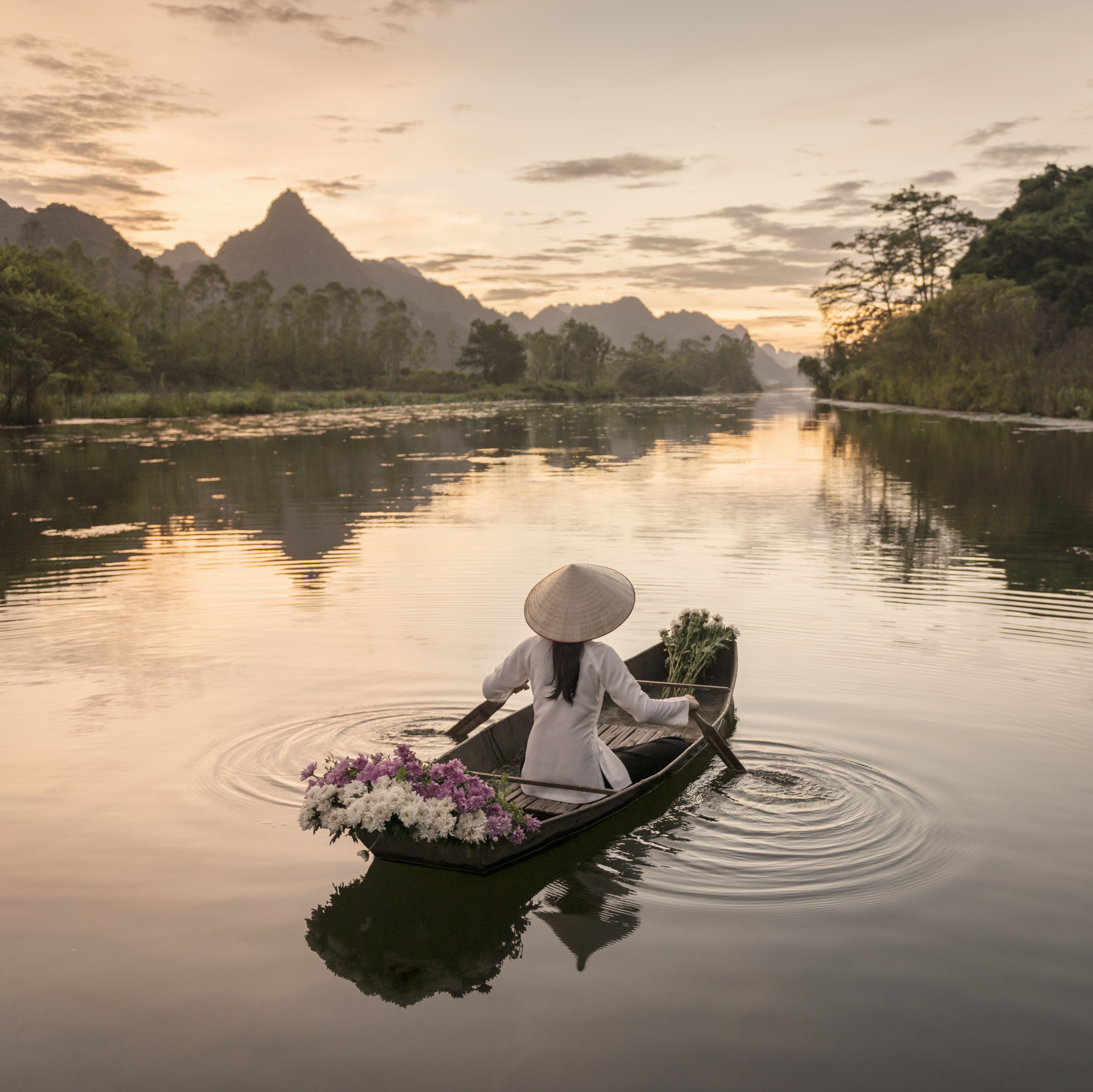 Take a tranquil boat ride down a river in Hanoi, Vietnam