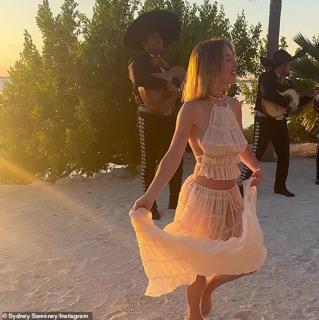 The Spokane-born, LA-raised bombshell shared a video of herself dancing barefoot on the beach while clad in a nude-colored halter top and matching maxi-skirt