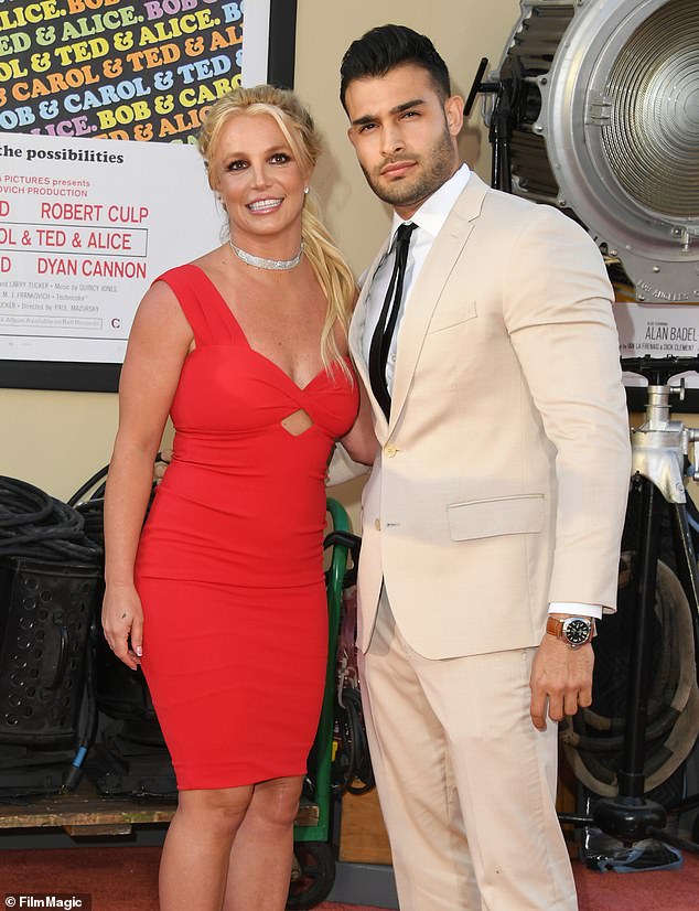 Sam began dating Britney in 2016 after he was cast as her love interest in her music video. In 2021, amid her legal battle to end her conservatorship, they announced their engagement (pictured 2019)