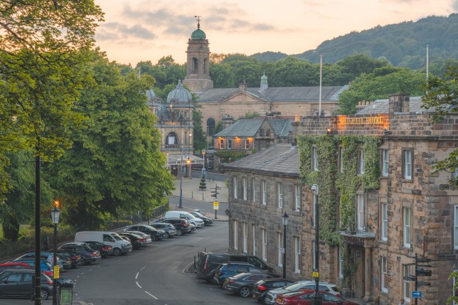 View over the main square in the historic market town of Buxton, Derbyshire, England with Old Hall Hotel, Opera House and St John's Church