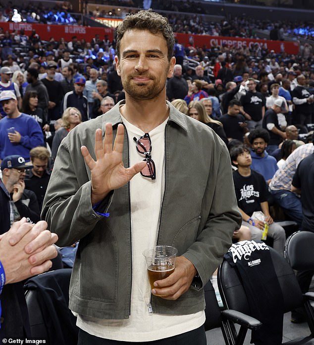 Theo James enjoyed a beer as he watched the Los Angeles Clippers take on the Dallas Mavericks at Crypto.com Arena in Los Angeles on Tuesday evening
