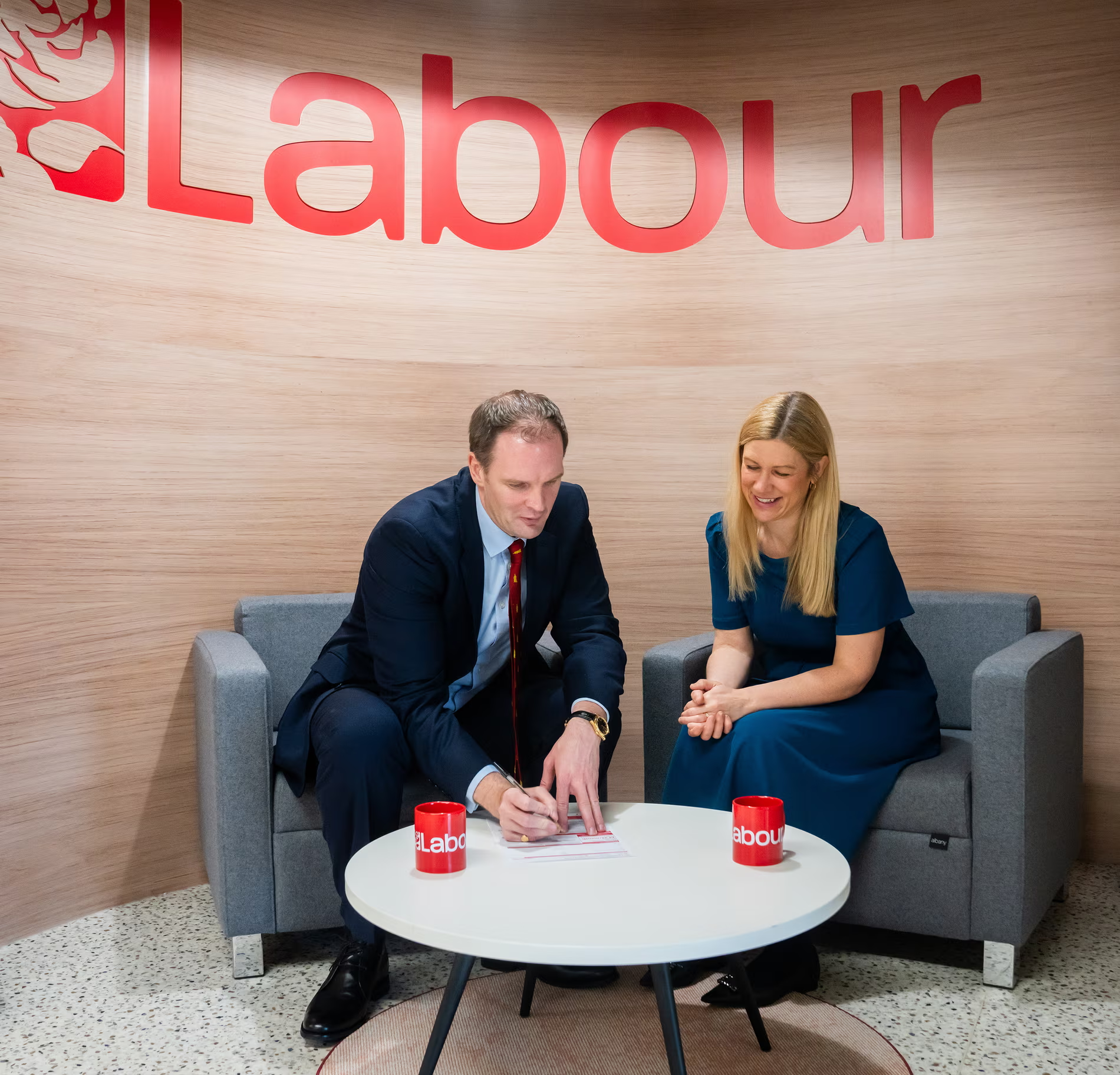 Dr Poulter signing his Labour membership form with MP Ellie Reeves
