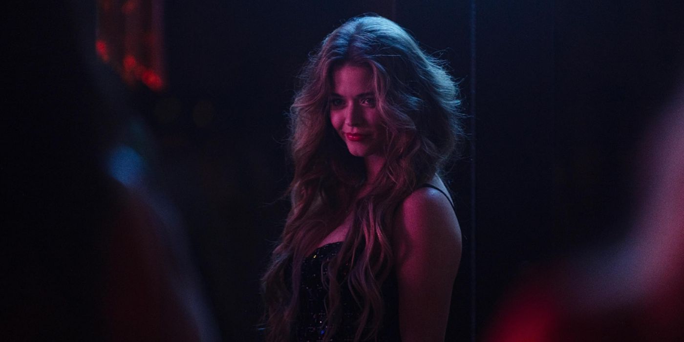 Sasha Pieterse with long hair in the middle of club staring at someone with a smile in 'The Image of You'