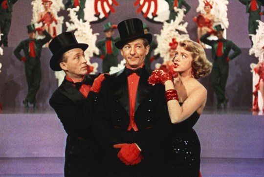 Bing Crosby, Danny Kaye and Rosemary Clooney in a still from the film White Christmas wearing matching black and red outfits