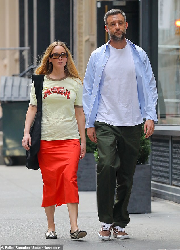 Jennifer Lawrence showed off her cool girl style while rocking a graphic t-shirt and bright red midi skirt on a night out with her husband Cooke Maroney