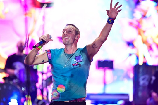 Chris Martin of Coldplay performing at Glastonbury 2024