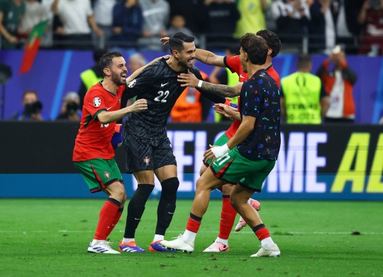 Portugal's Diogo Costa with teammates celebrate after winning the penalty shoot-out