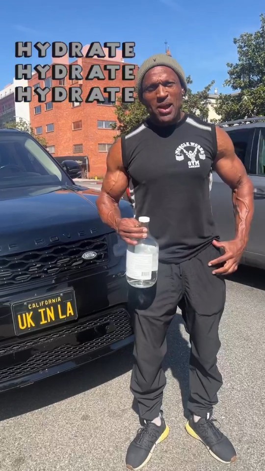 Mark Smith, aka Rhino from Gladiators, standing in a car park with a bottle of water