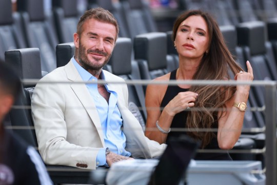 David Beckham and Victoria Beckham sitting together at a Miami stadium