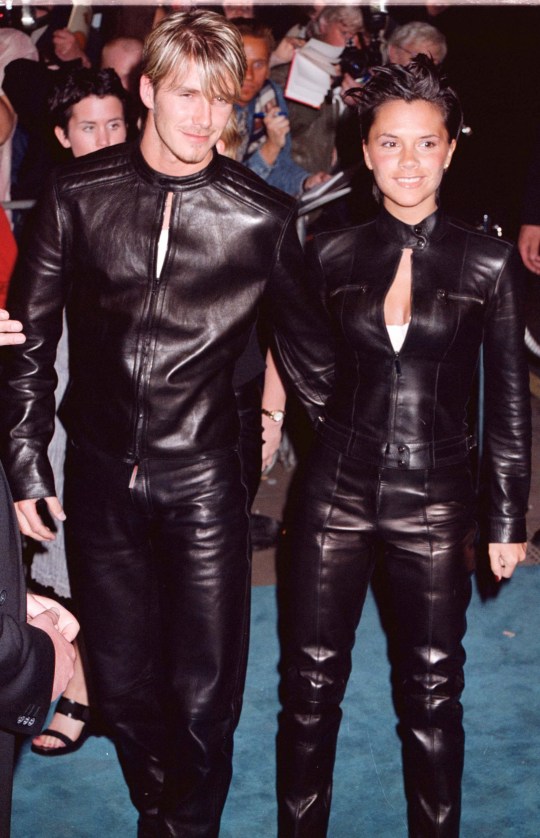 David Beckham and Victoria Beckham both wearing leather outfits at an event