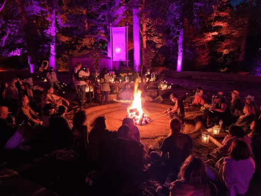 Festivalgoers sat around the warmth of a fire as prayer-like songs were sung (Picture: Danny Rigg)