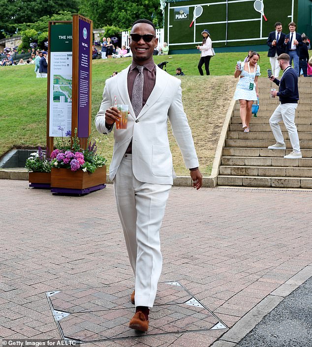 The dancer beamed from ear to ear as he enjoyed one of Wimbledon's famous Pimms