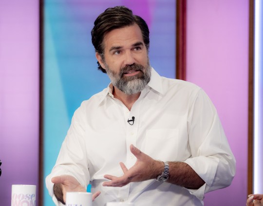 Rob Delaney holds his hand up mid conversation while on the talk show, Loose Women