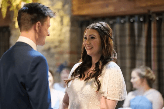 Rachel at her wedding day with her husband, at the alter