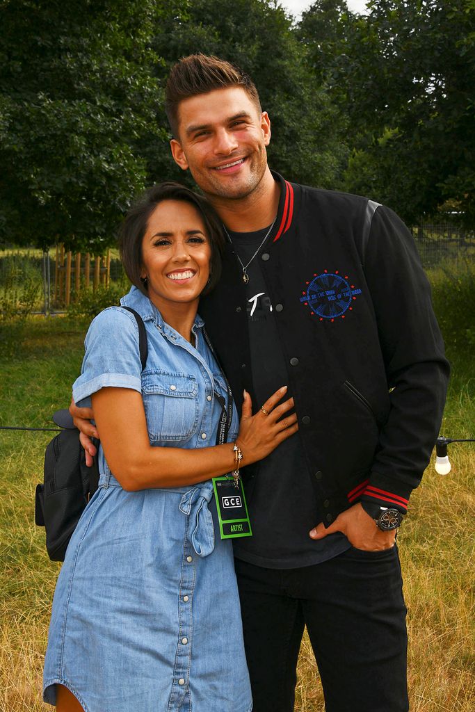 Janette Manrara in a denim dress and Aljaz Skorjanec in a bomber jacket