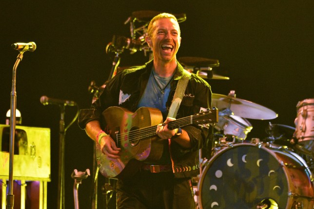 Chris Martin of Coldplay performing at Glastonbury 2024