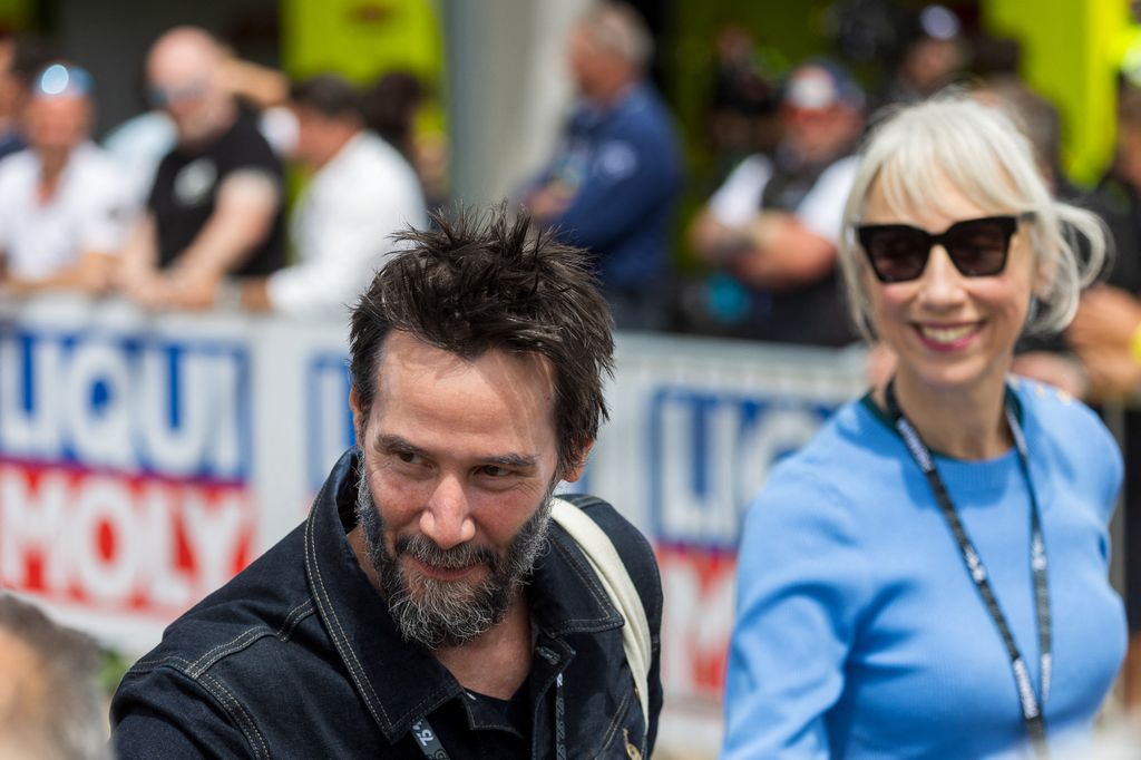 Keanu Reeves and partner Alexandra Grant attend the German Motorcycle Grand Prix at the Sachsenring racetrack 
