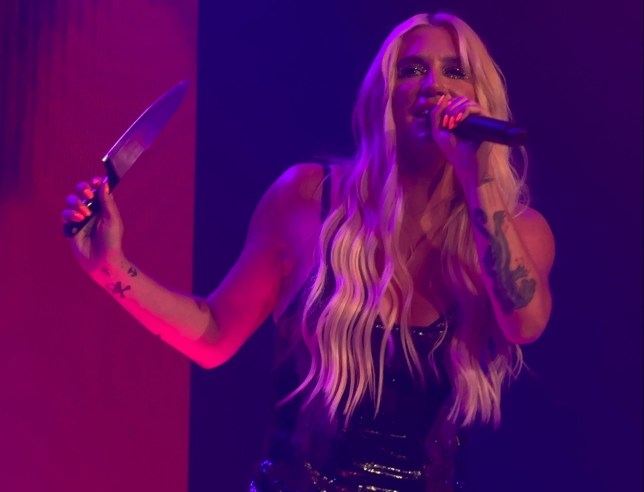Kesha on stage in Atlantic City with a knife