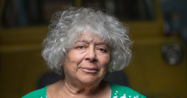 Miriam Margolyes wearing a green and white and green blouse while appearing concerned