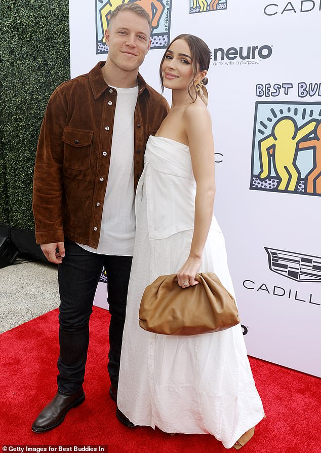 Christian McCaffrey, 28, came to the defense of his wife, Olivia Culpo, 32, after a style influencer labeled her Dolce & Gabbana wedding dress as 'nothing' and 'absence of personality'; seen in 2023 in L.A.