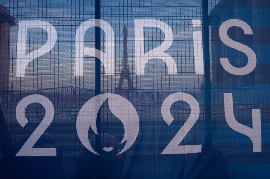 The Eiffel Tower is seen behind an Olympic canvas in Paris, France on July 18,2024.