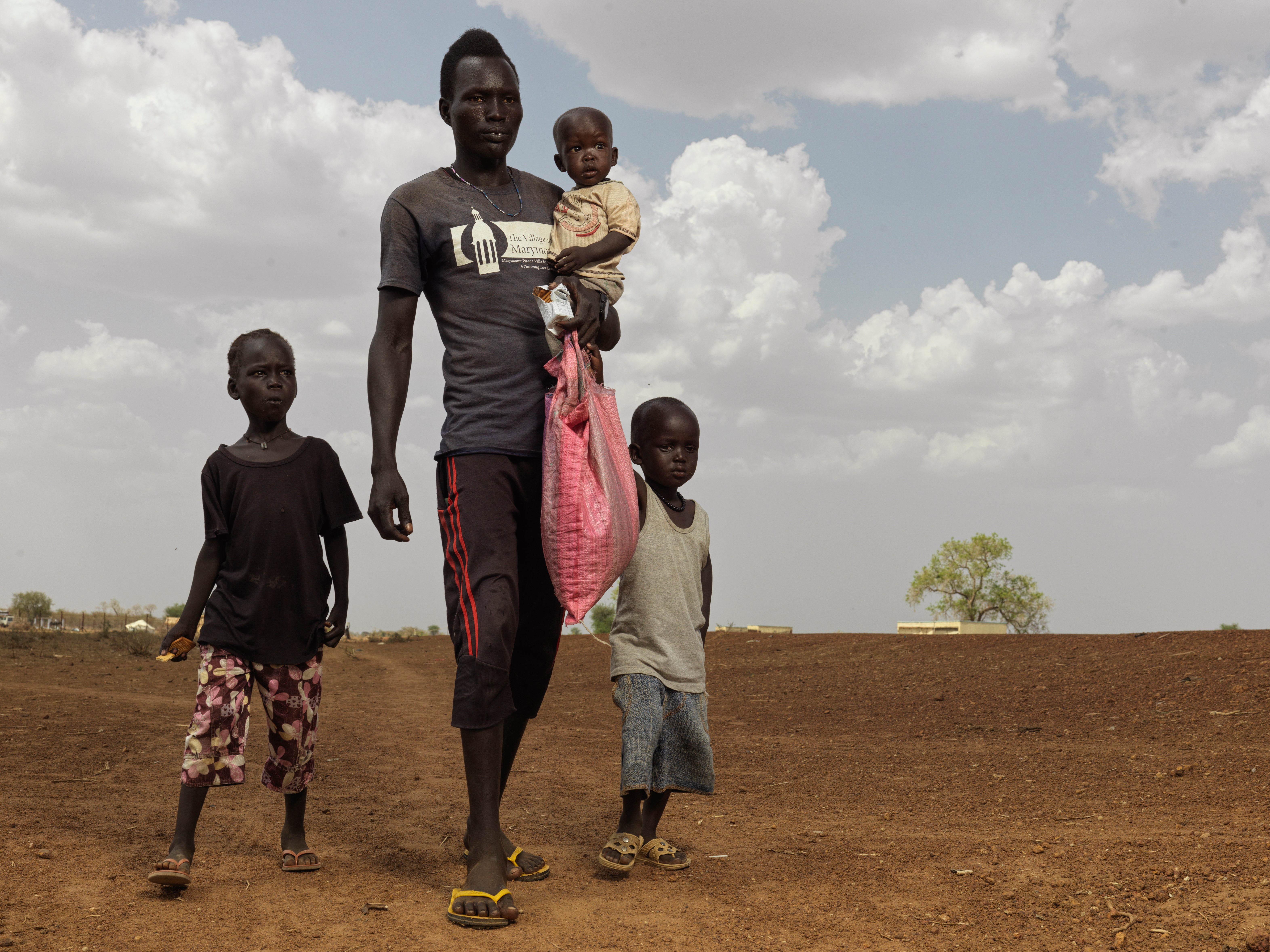 Dhieng Bol Deng and his family arrive with only a few of their belongings