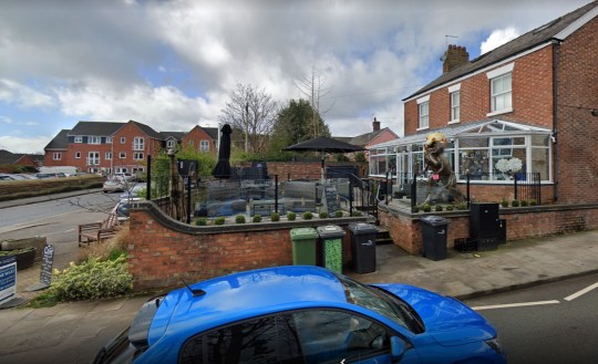 PIC FROM Kennedy News/Google Maps (PICTURED: MIOLA, HOLMES CHAPEL, WITH THE T-REX IN VIEW BEFORE IT WAS SOLD, DRESSED IN EASTER CLOTHES) A dad gave his dinosaur-mad son a 21st birthday present he'd never forget - a 7ft tall T-REX statue that 'roars' at his neighbours from the driveway. Matthew Riddell-Rovira saw homeware shop Miola, in Holmes Chapel, Cheshire, was closing down and selling its iconic metal dinosaur sculpture. When he asked dad Dave Rovira to buy it the 56-year-old was going to reject the 'wild' idea but mum Blanch Rovira thought it'd make a great early 21st birthday present. DISCLAIMER: While Kennedy News and Media uses its best endeavours to establish the copyright and authenticity of all pictures supplied, it accepts no liability for any damage, loss or legal action caused by the use of images supplied and the publication of images is solely at your discretion. SEE KENNEDY NEWS COPY - 0161 697 4266