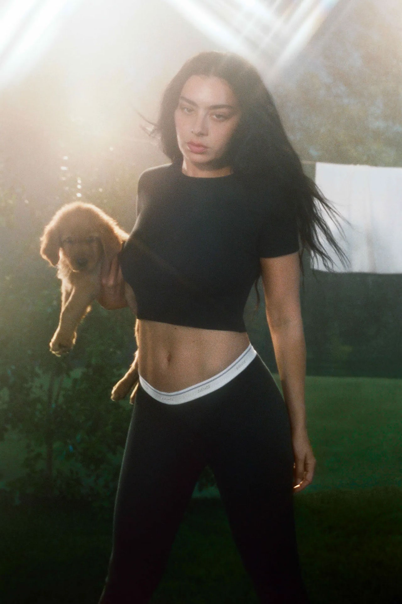 Image may contain Charli XCX Face Head Person Photography Portrait Animal Canine Dog Mammal Pet Puppy and Adult