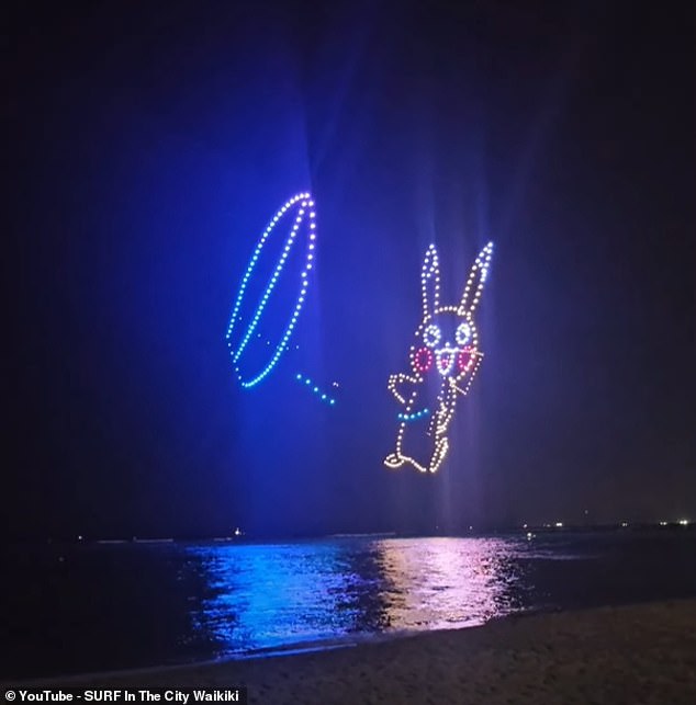 Above, another image of the 2024 Pokémon World Championships drone light show in Honolulu, Hawaii - this one depicting Pikachu, a popular 'electric' type pokémon - captured on video by a local surf shop