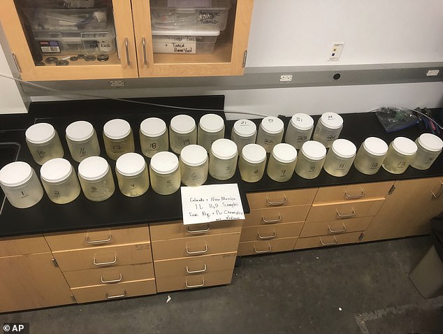 This July 22, 2024, image provided by biochemist Michael Ketterer shows jars of water samples from Acid Canyon in Los Alamos, New Mexico